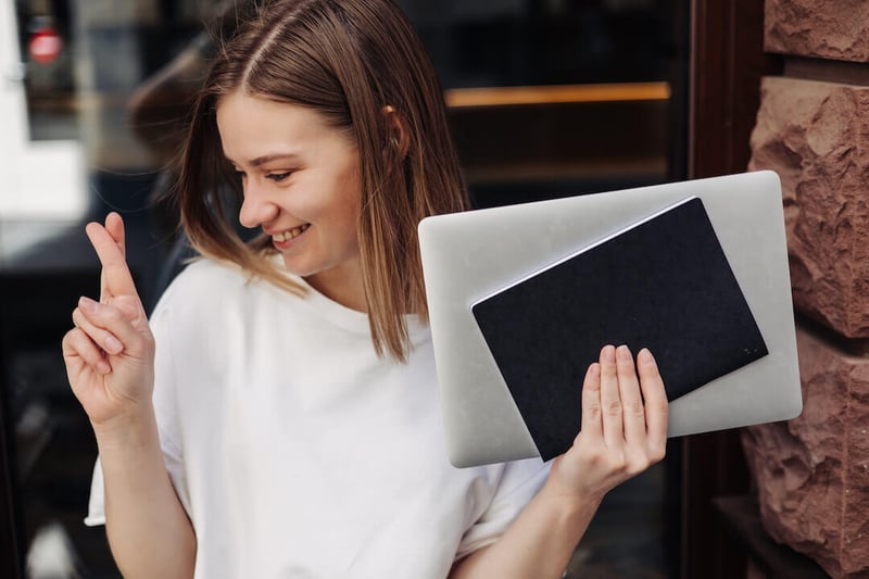 young-beautiful-woman-holding-workbooks-smiling